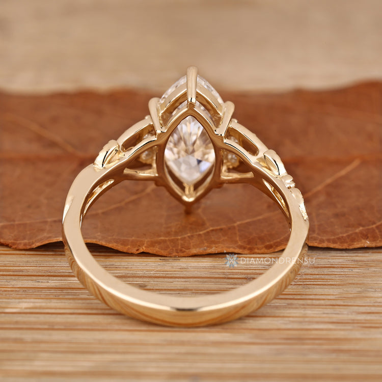 Marquise diamond ring with handcrafted seven stone design.