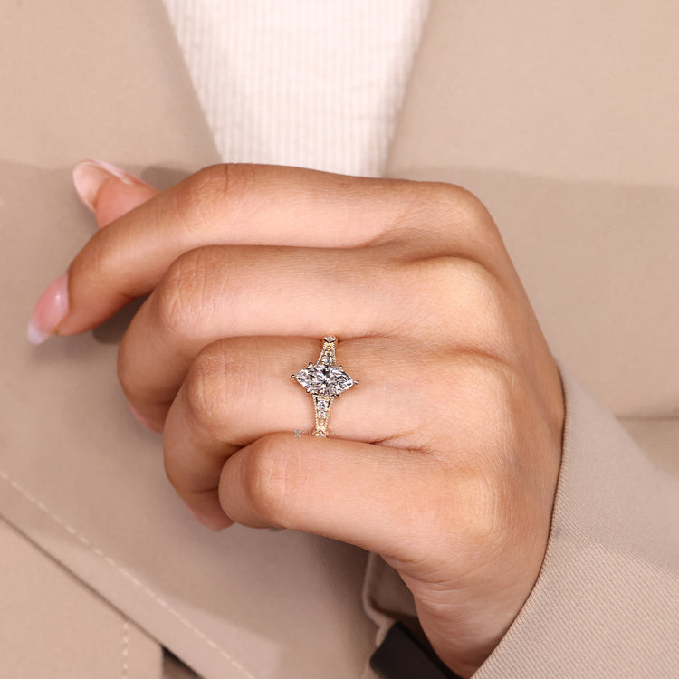 Vintage marquise ring with round side stone accents.