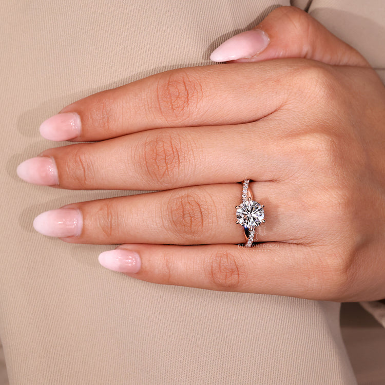 Lab grown round diamond ring with round cut pave band and claw prongs.