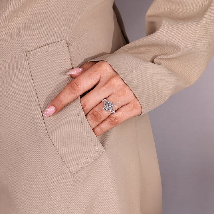 Nature inspired engagement ring with marquise side stone details.