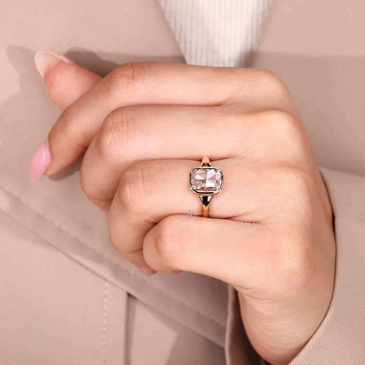 Cushion rose cut diamond ring with bezel style setting.