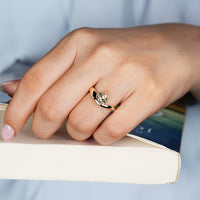 East to west setting complements this cushion old mine cut ring.
