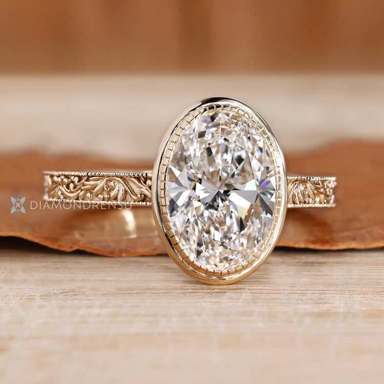 Handmade oval diamond ring with milgrain details.