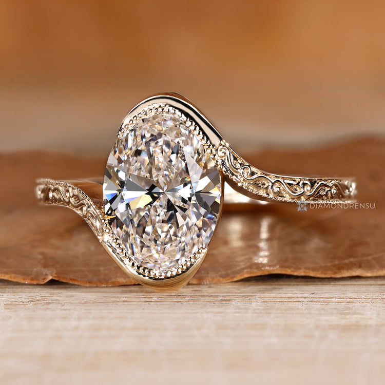 Oval diamond ring with a bypass setting.