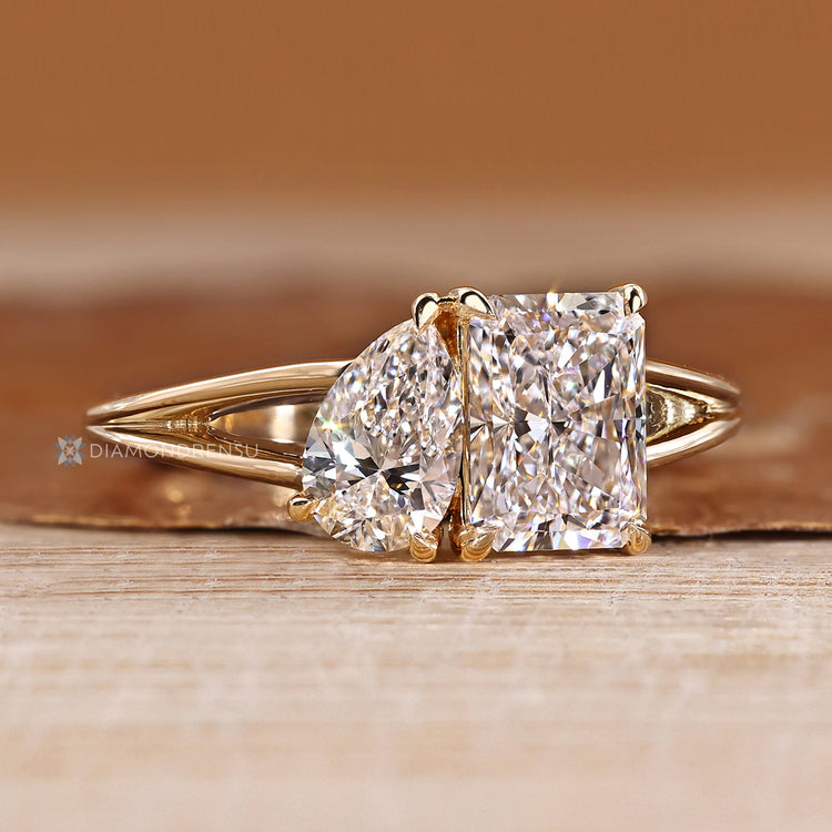 Prong setting secures the pear and radiant stones.