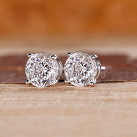 Handmade diamond stud earrings with Portuguese cut center stones.
