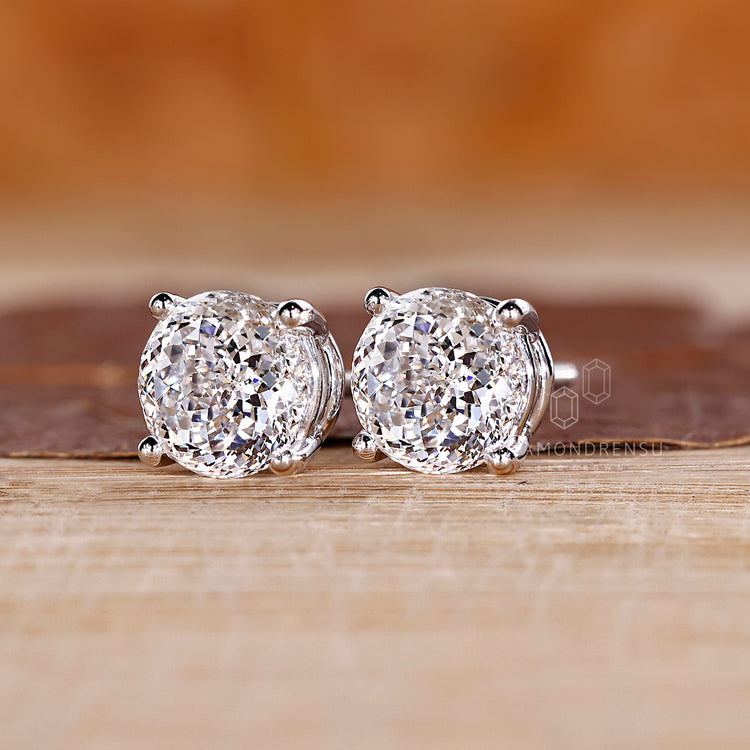 Handmade diamond stud earrings with Portuguese cut center stones.