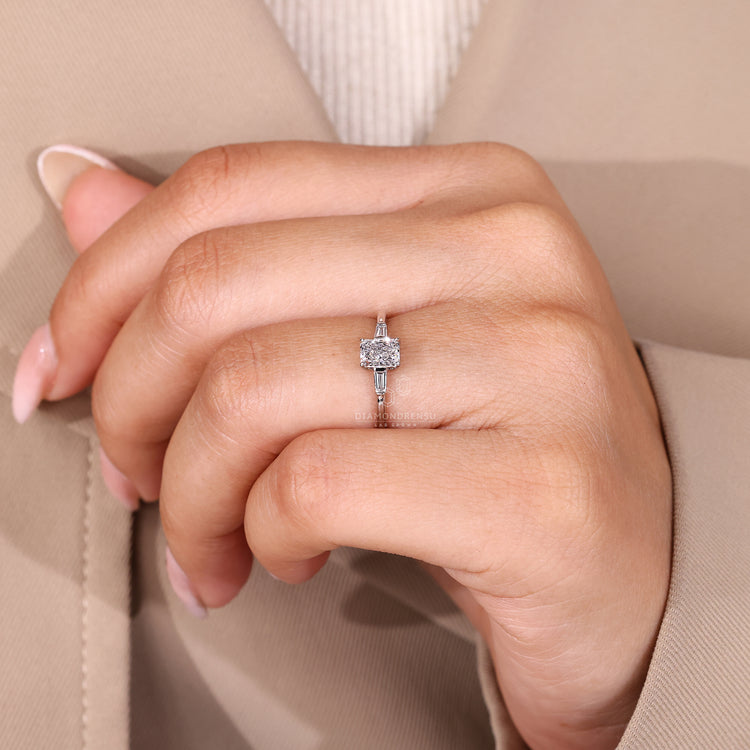 Three diamond ring with IGI certification and tapered baguette accents.