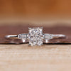 Three diamond ring with radiant cut center and tapered baguette side diamonds.
