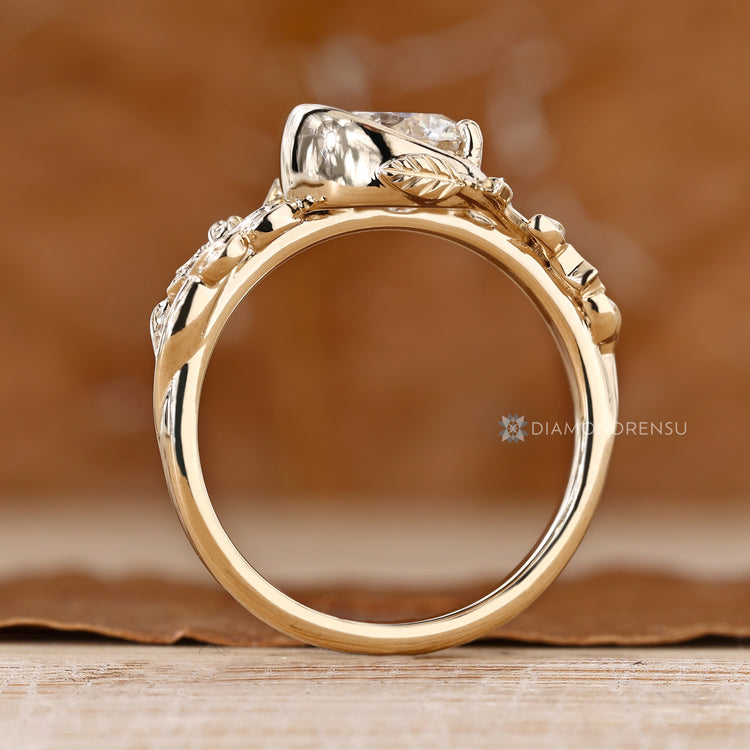 Nature inspired ring with round diamond side stones.
