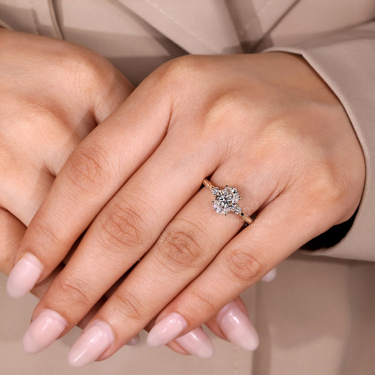 Oval centre stone ring with round diamonds and four prong setting.