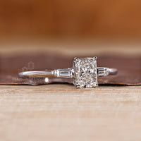 Three diamond engagement ring with radiant cut center and tapered side stones.