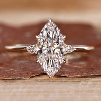 Three stone marquise diamond ring with pear side stones.