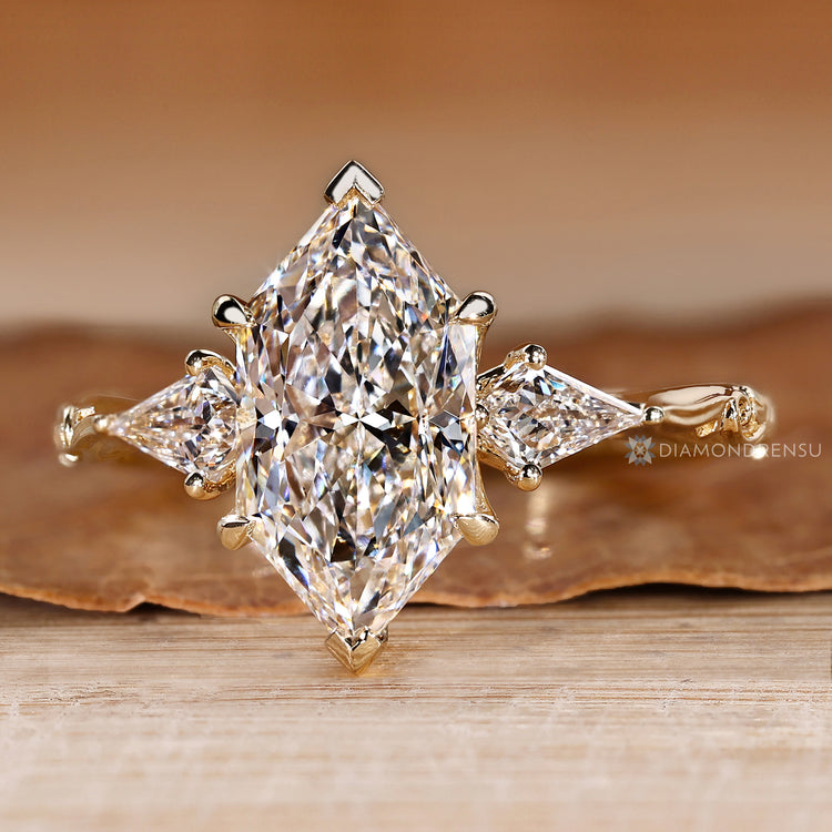Dutch marquise trilogy ring with a four claw prong setting.