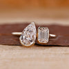 Toi et moi ring pear emerald diamonds cathedral setting.