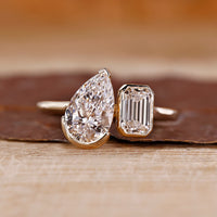 Toi et moi ring pear emerald diamonds cathedral setting.