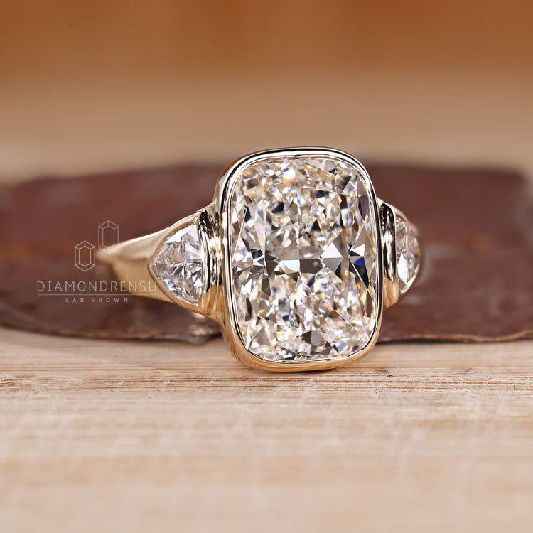 Handmade three diamond ring with cushion and trillion cuts.
