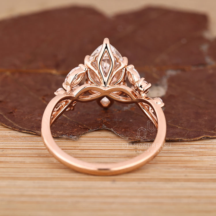 Handmade engagement ring with marquise cut and nature inspired design.