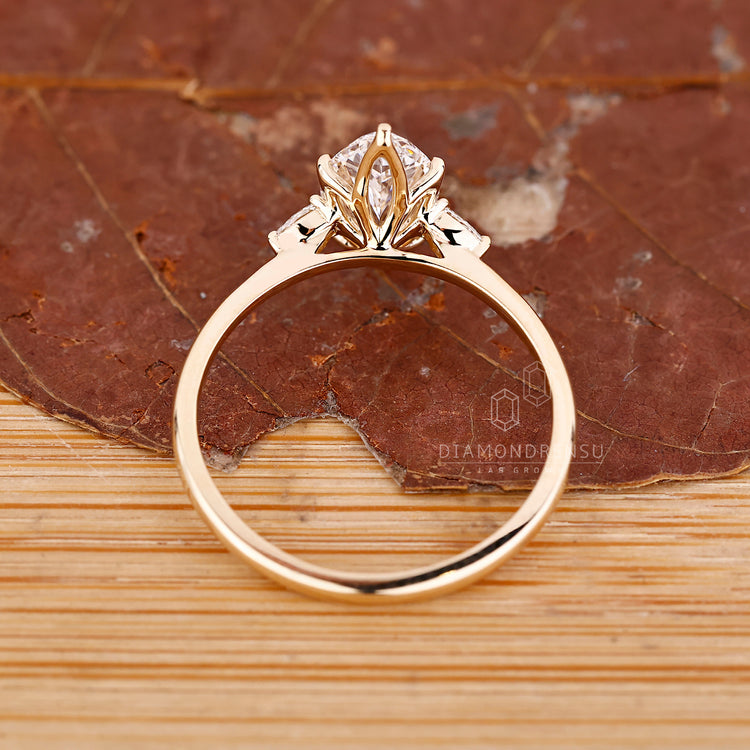 Lab grown marquise diamond ring with pear accents.