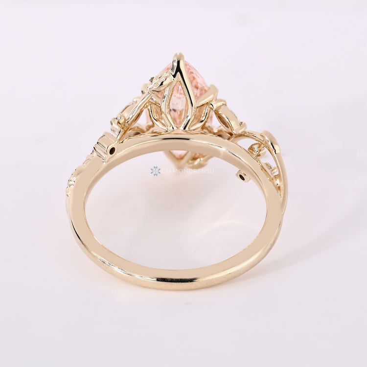 Pink marquise center stone with round and marquise side stones.
