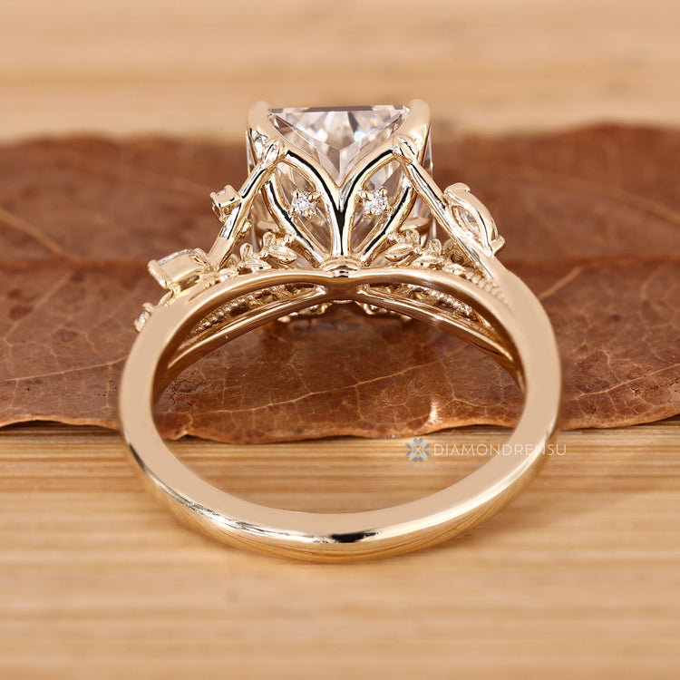 Radiant cut ring with tulip setting and hidden round diamonds.