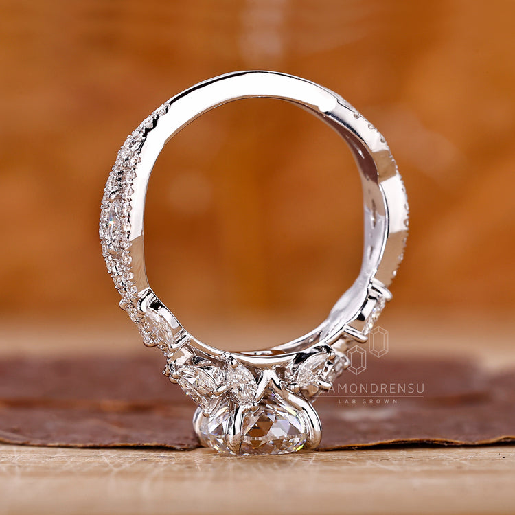 Vintage style Portuguese cut diamond ring with marquise and round stones.