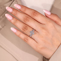 Nature inspired ring with marquise and round side stone details.