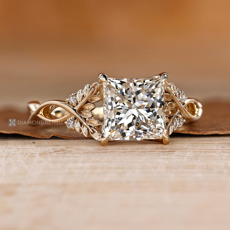 Princess cut diamond ring with a four claw prong setting.