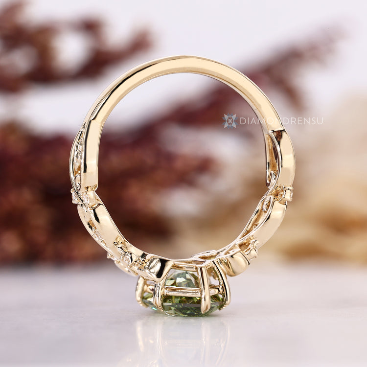 Green Dutch marquise diamond ring with a twisted shank and leaf style prongs.