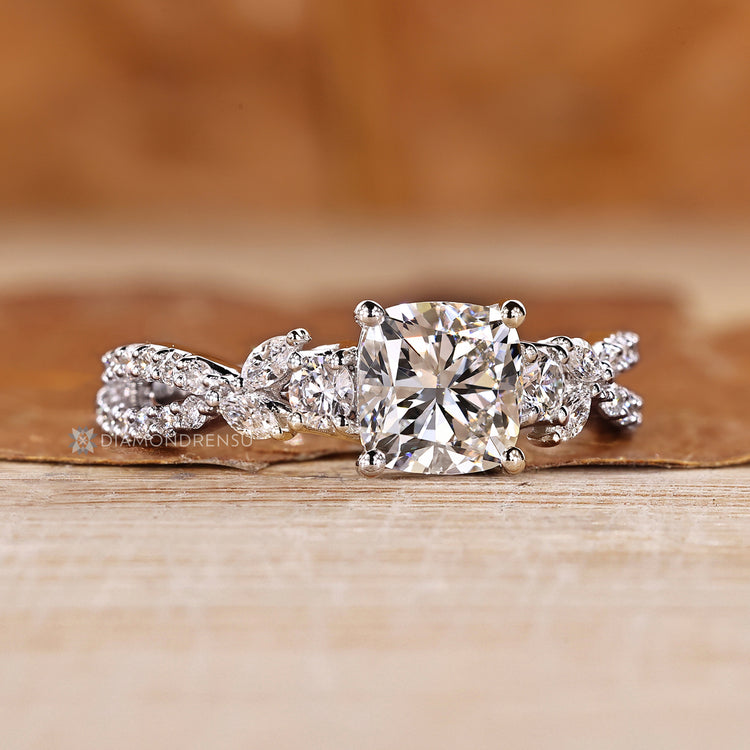 Cluster setting complements the marquise and round side stones.