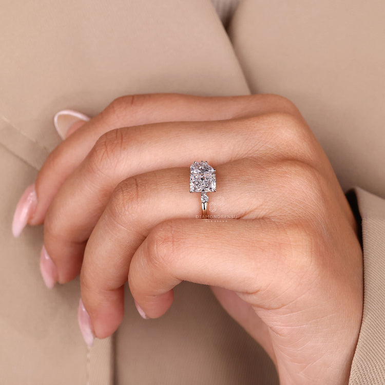 Two stone ring with round cut side stones and pear shaped diamond.