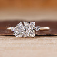 Two stone engagement ring with pear and radiant diamonds and round accents.