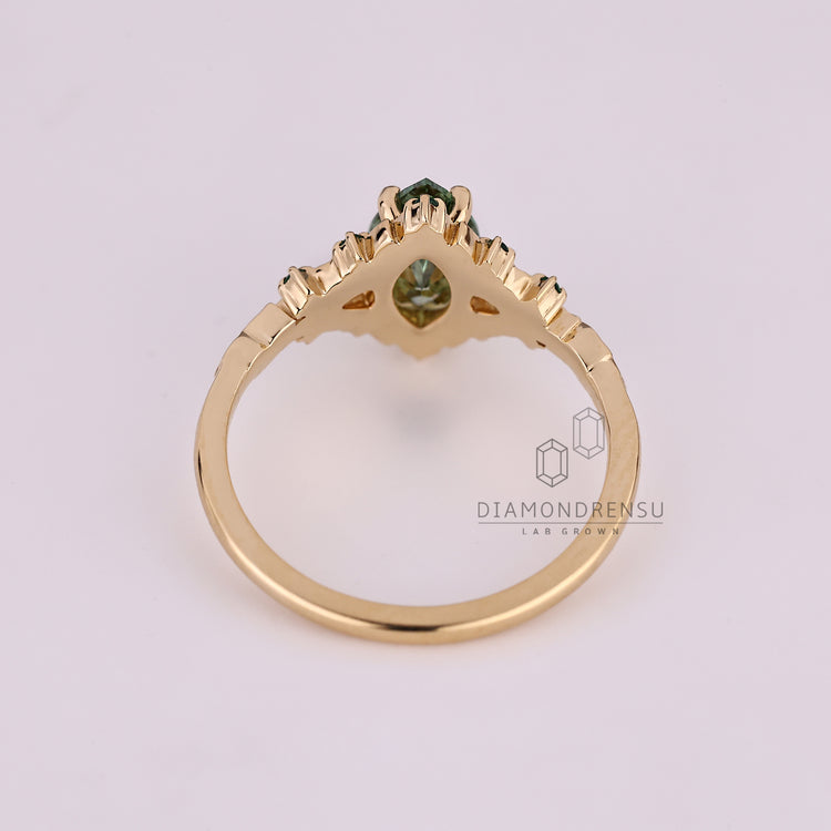 Handmade marquise ring with emerald gemstone and prong setting.