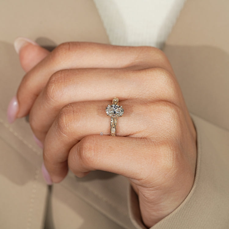 Oval lab grown diamond ring with four claw prongs.