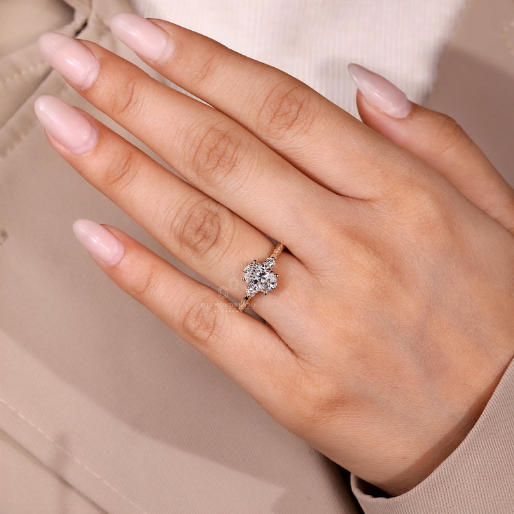 Handmade three stone ring with oval diamond and filigree design.