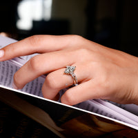The muse setting complements the marquise center stone and side stones.