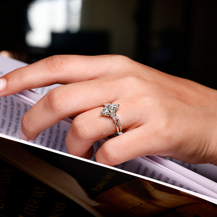 The muse setting complements the marquise center stone and side stones.