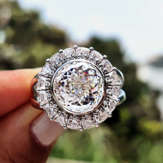 Vintage moissanite engagement ring with a Portuguese cut design in an elegant white gold setting.