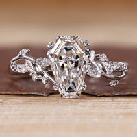 Nature inspired engagement ring with coffin center stone and side accents.