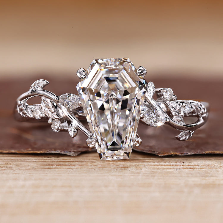 Nature inspired engagement ring with coffin center stone and side accents.