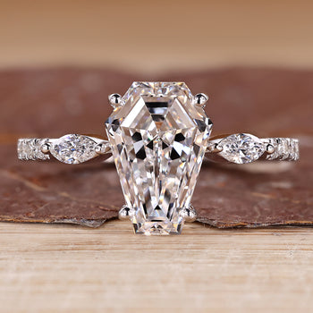 Coffin shaped diamond ring with marquise side stones and pave style band.