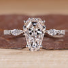 Coffin shaped diamond ring with marquise side stones and pave style band.