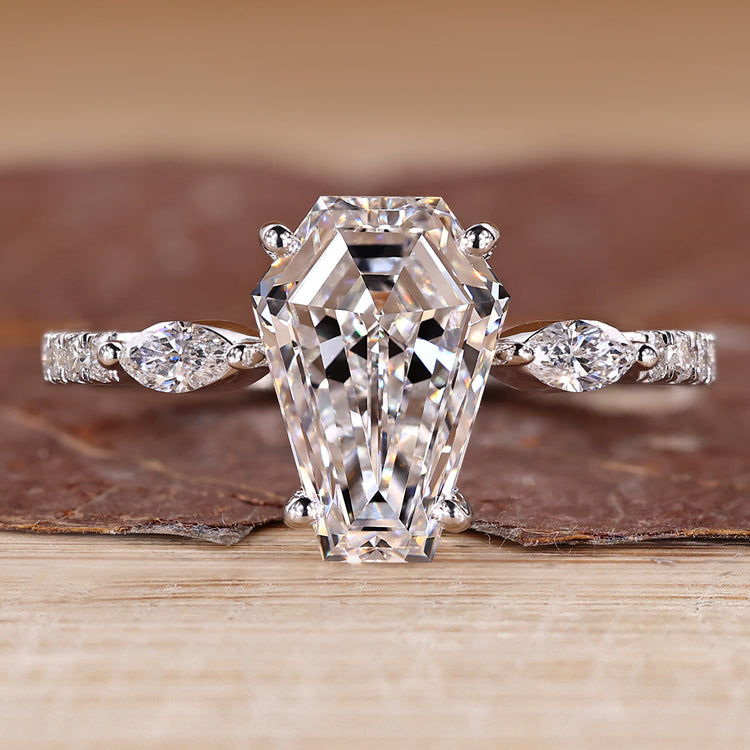 Coffin shaped diamond ring with marquise side stones and pave style band.