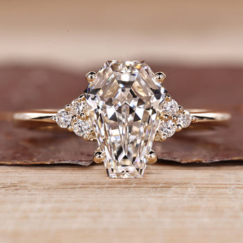 Coffin cut diamond ring with round side stones and seven stone style.