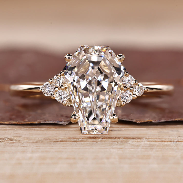 Coffin cut diamond ring with round side stones and seven stone style.