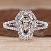 Split shank diamond ring with coffin center stone and halo style.