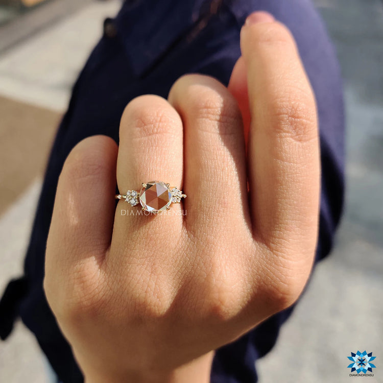 Muse ring design in yellow gold with moissanite center stone.
