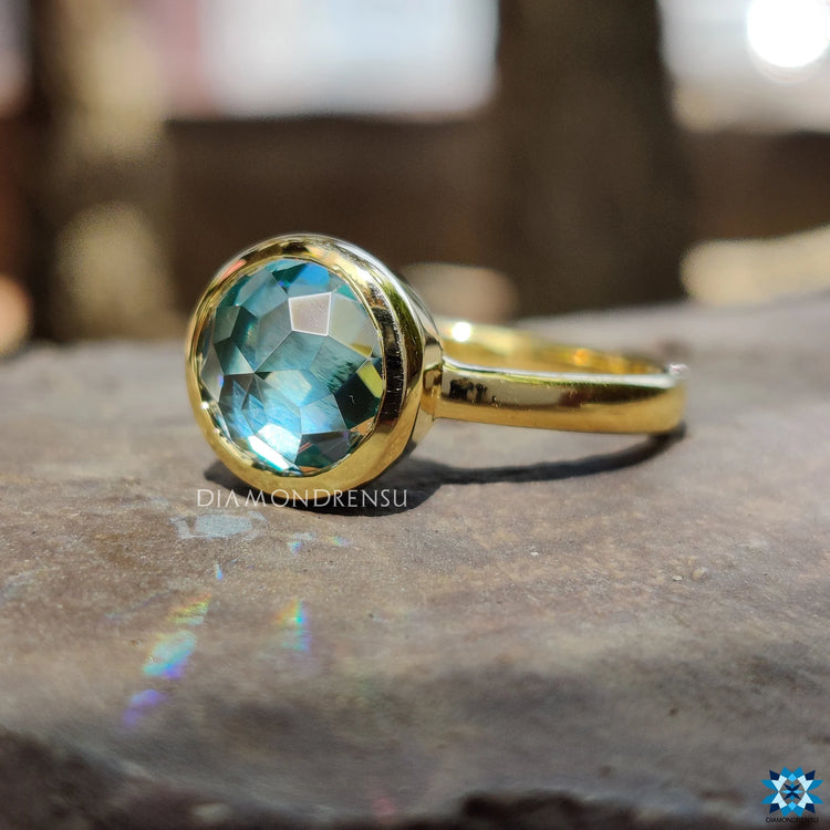 Round cut bezel ring with a sleek modern look.