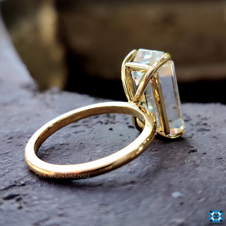 Handmade jewelry featuring a bright emerald moissanite stone.
