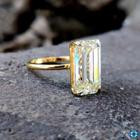 Custom moissanite ring styled with a modern emerald cut.
